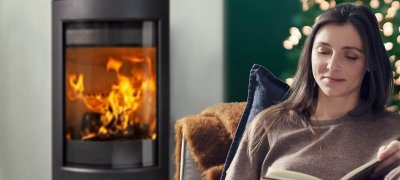 Christmas with woman in front of a fireplace