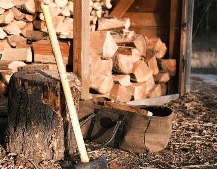 Wood is hide with firewood and ax 