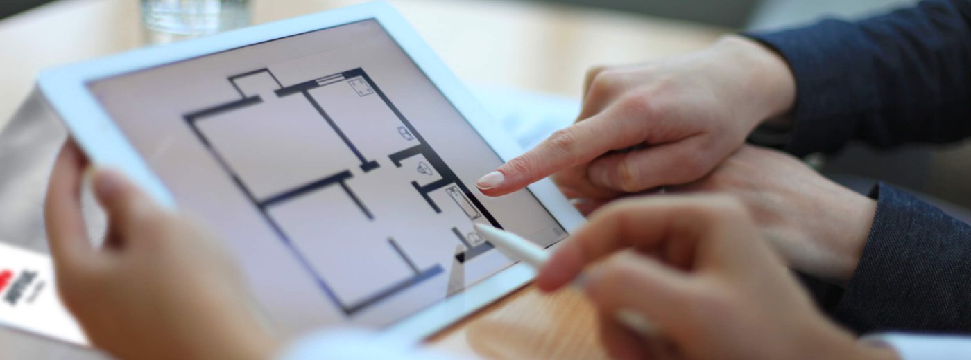 Hands pointing at iPad with Jøtul catalog 